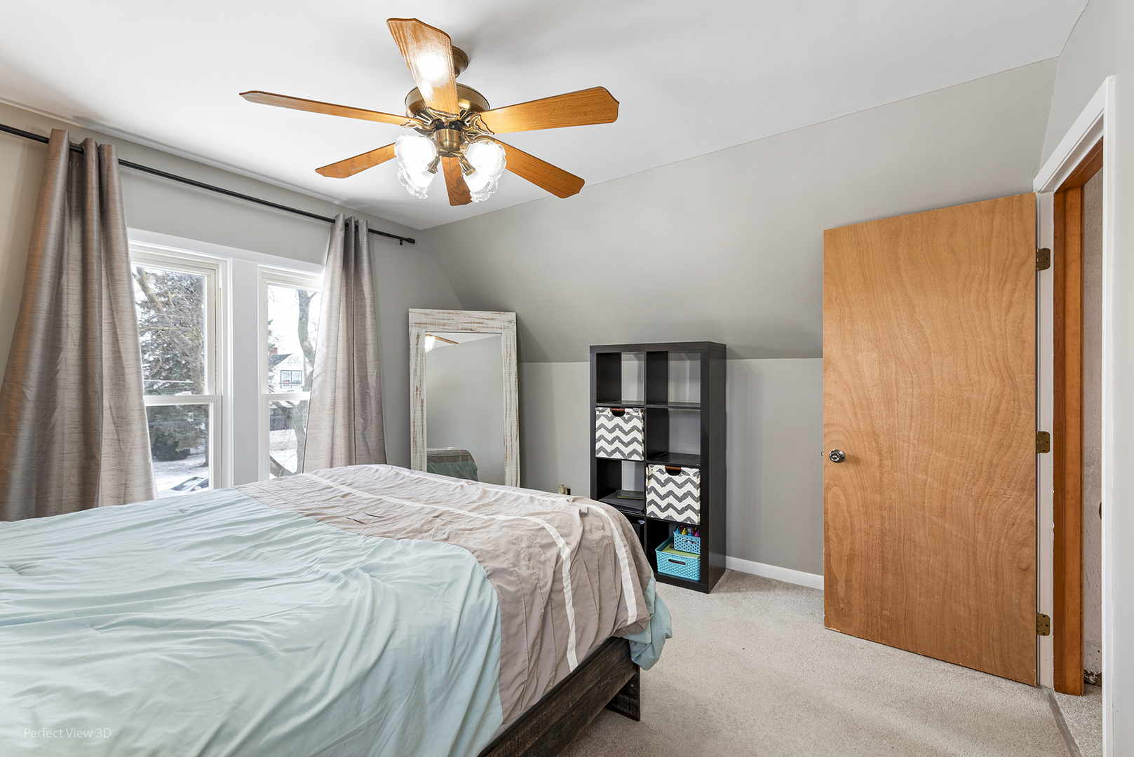 733 North 13th Street DeKalb, IL 60115 - Photo 13 of 22 a bedroom with a large bed and a chandelier