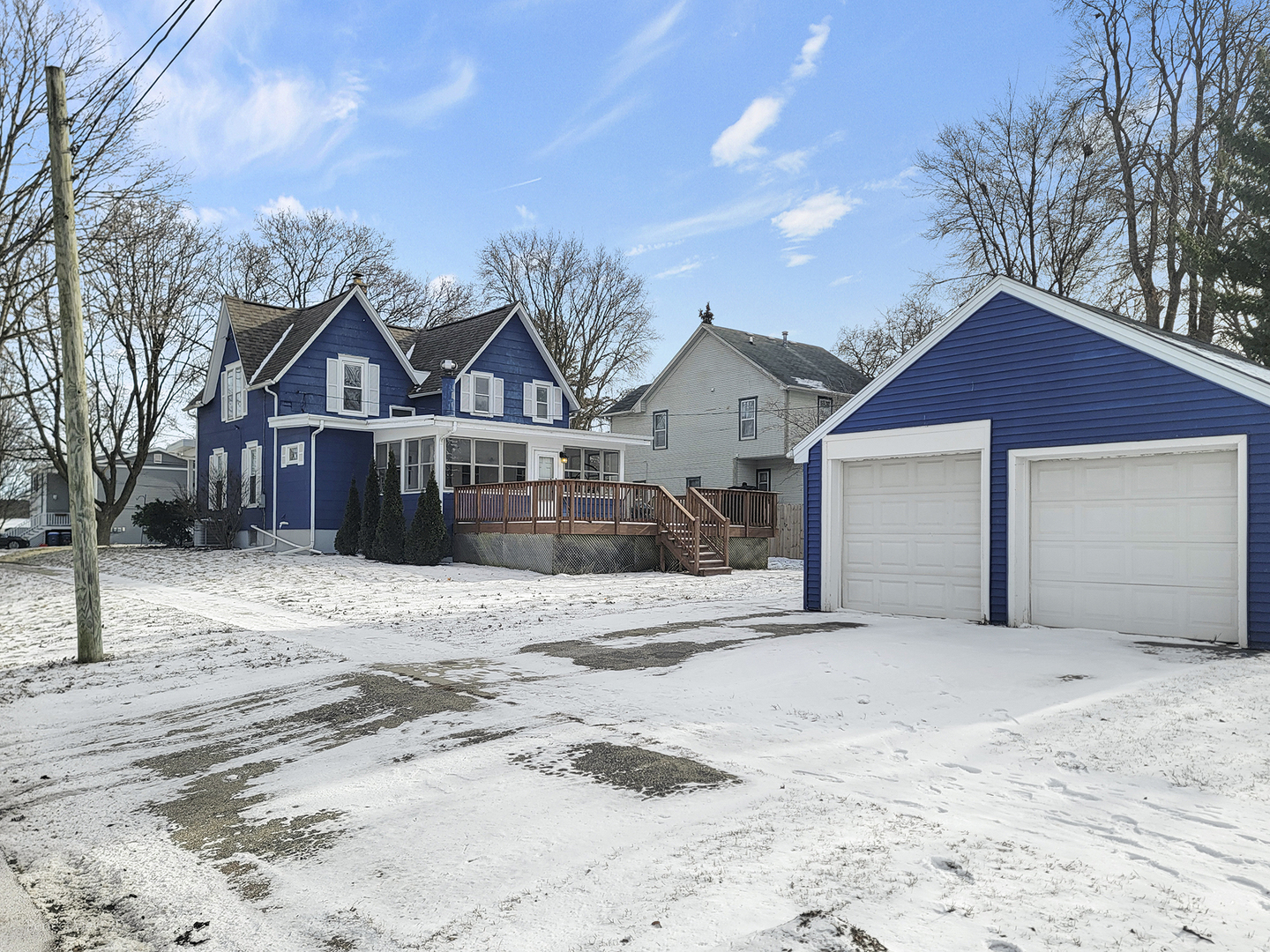 733 North 13th Street DeKalb, IL 60115 - Photo 3 of 22 a front view of a house with a yard covered in snow