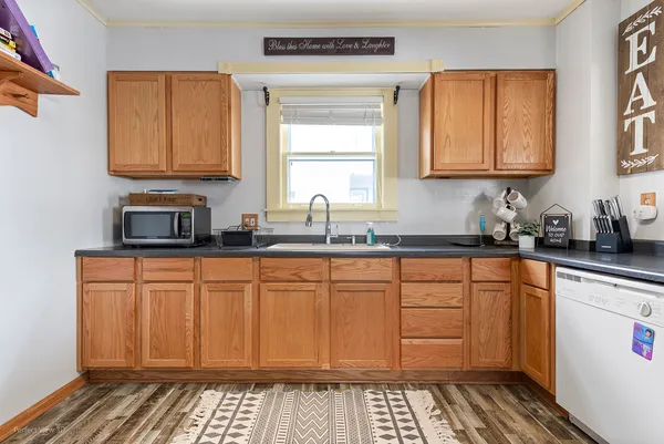 a kitchen with stainless steel appliances a sink stove and cabinets