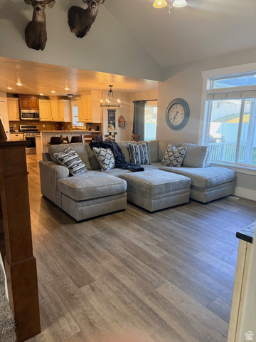 580 Cherry Ridge Lane Richmond, UT 84333 - Photo 7 of 53 Living room with light wood-type flooring, vaulted ceiling, and suspended lighting