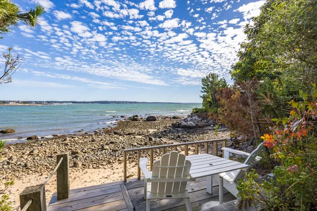 a kitchen with granite countertop a sink and white cabinets
