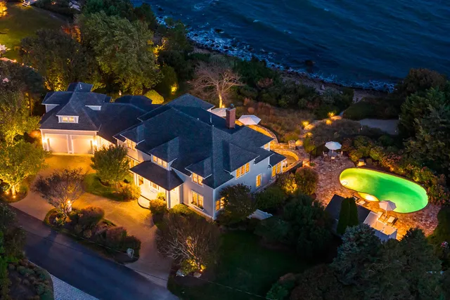 an aerial view of a house with a swimming pool and outdoor space