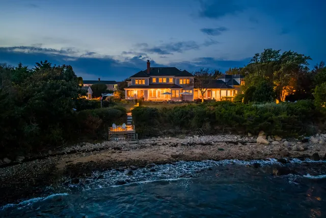 a view of a couches in the patio next to a yard