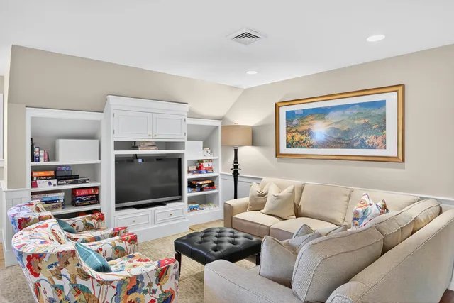 a bedroom with furniture and a large window