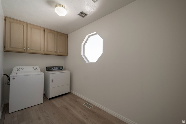 11922 Bluff View Drive Sandy, UT 84092 - Photo 10 of 30 Laundry area with light wood finished floors, washer and dryer, and cabinet space