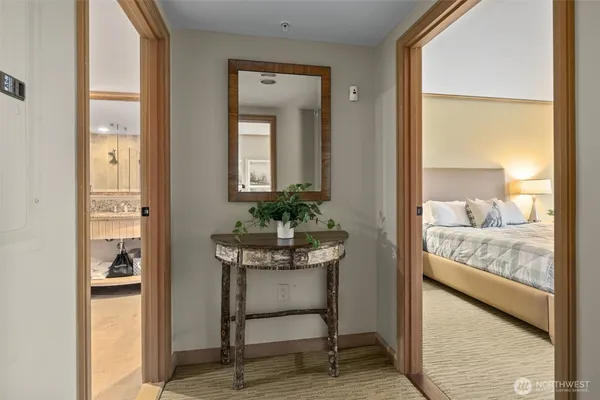a view of a hallway and a livingroom with furniture