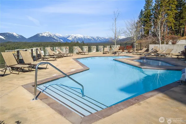a view of a swimming pool with a table and chairs