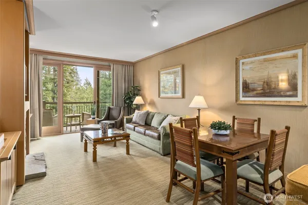 a living room with furniture and a floor to ceiling window