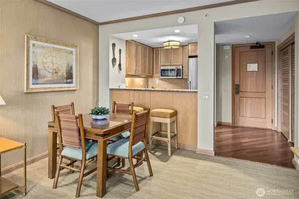 a view of a dining room with furniture and wooden floor