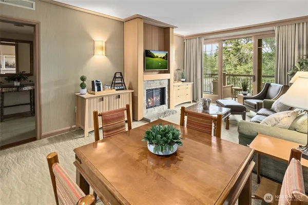 a living room with furniture fireplace and a large window