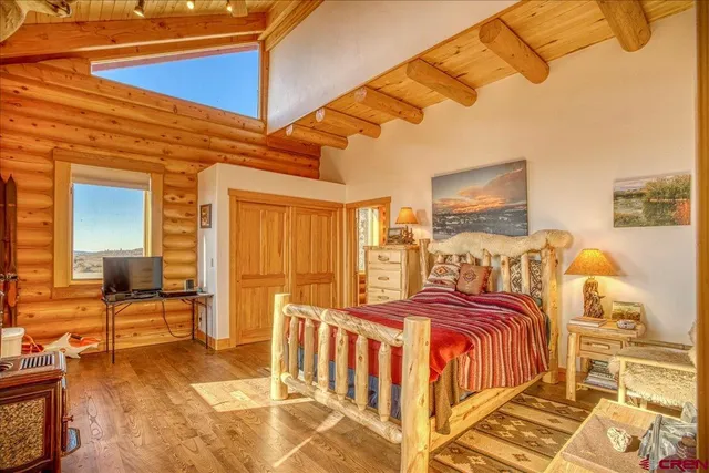 a bedroom with furniture and a flat screen tv