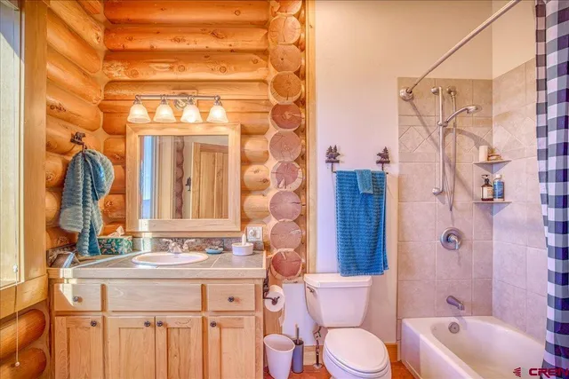 a bathroom with a granite countertop toilet sink and shower