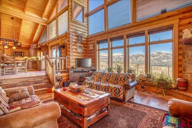 a living room with furniture a rug and a large window