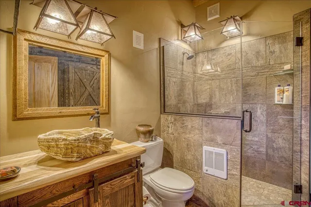 a bathroom with a granite countertop toilet sink and shower
