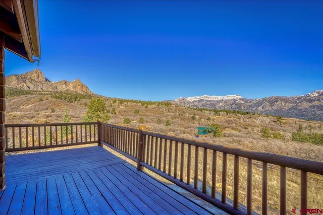a view of a balcony with wooden fence