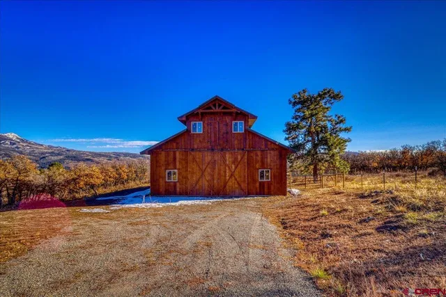 a view of a yard with a house in the background