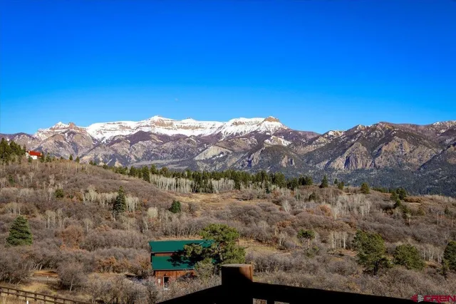 a view of a house with a mountain in the background