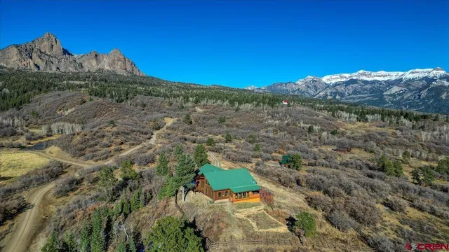 a view of a mountain with a mountain in the background