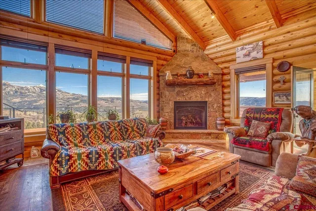 a living room with furniture a fireplace and wooden floor