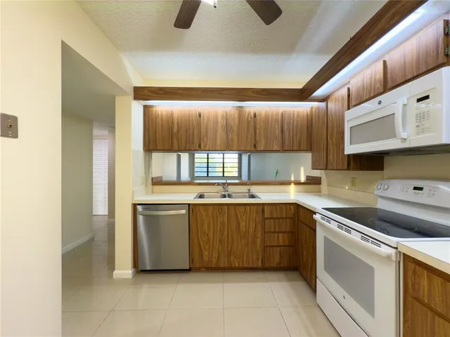 a kitchen with a sink a stove and refrigerator