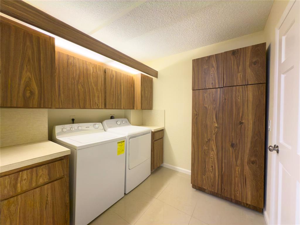 1701 Whitehall Drive, Unit 303 Davie, FL 33324 - Photo 13 of 33 a utility room with dryer and washer