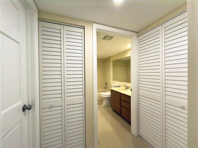 a bathroom with a sink double vanity granite toilet tub and shower