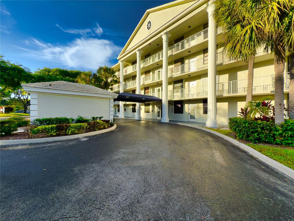 1701 Whitehall Drive, Unit 303 Davie, FL 33324 - Photo 2 of 33 a front view of a house with a garden