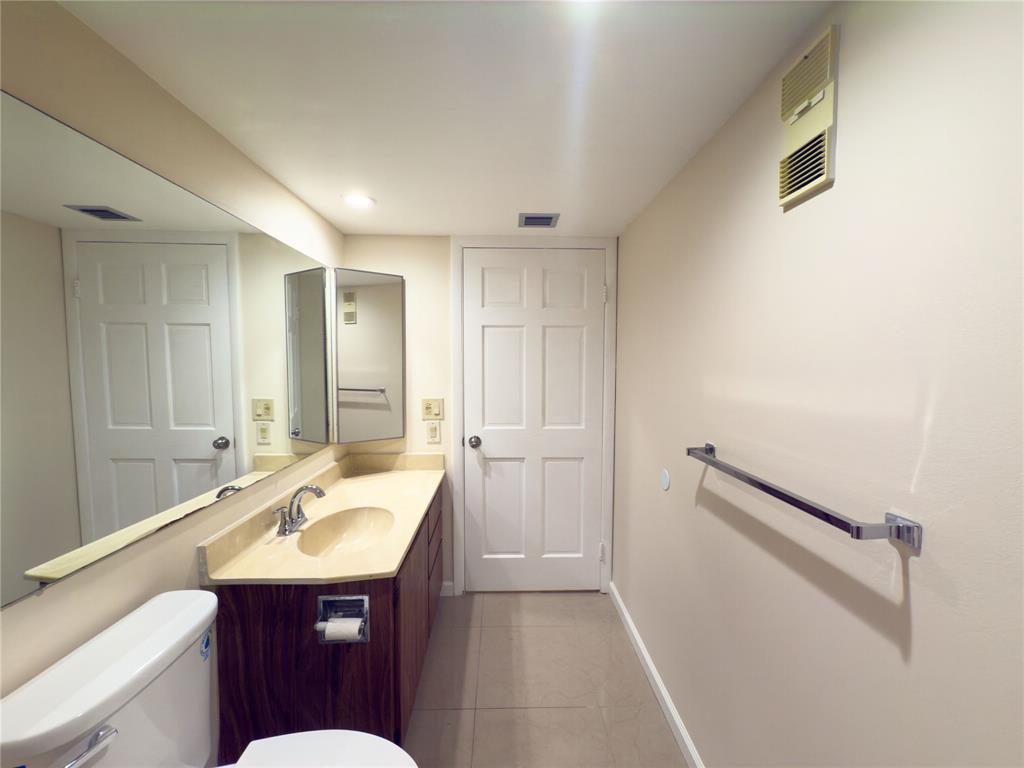 1701 Whitehall Drive, Unit 303 Davie, FL 33324 - Photo 23 of 33 a bathroom with a sink and mirror