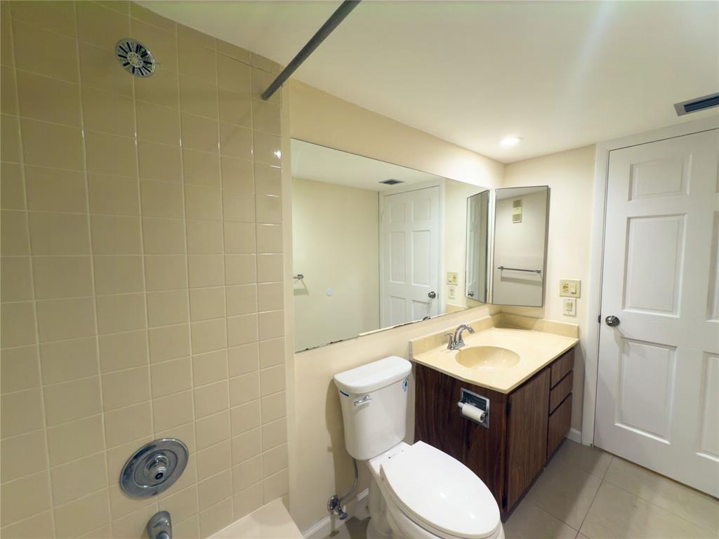1701 Whitehall Drive, Unit 303 Davie, FL 33324 - Photo 24 of 33 a bathroom with a sink a toilet and shower