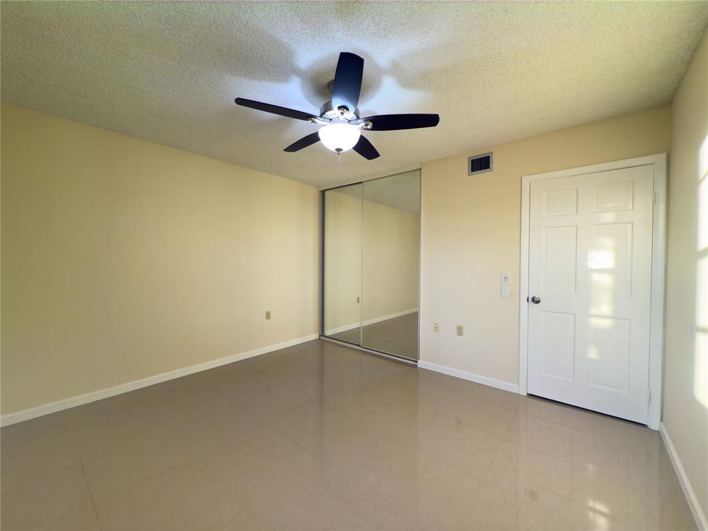 1701 Whitehall Drive, Unit 303 Davie, FL 33324 - Photo 25 of 33 an empty room with closet and a chandelier fan