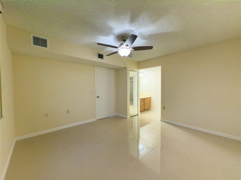 1701 Whitehall Drive, Unit 303 Davie, FL 33324 - Photo 26 of 33 an empty room with a ceiling fan and a window