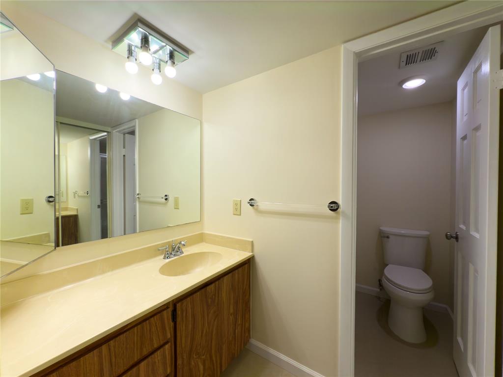 1701 Whitehall Drive, Unit 303 Davie, FL 33324 - Photo 28 of 33 a bathroom with a sink a toilet and shower