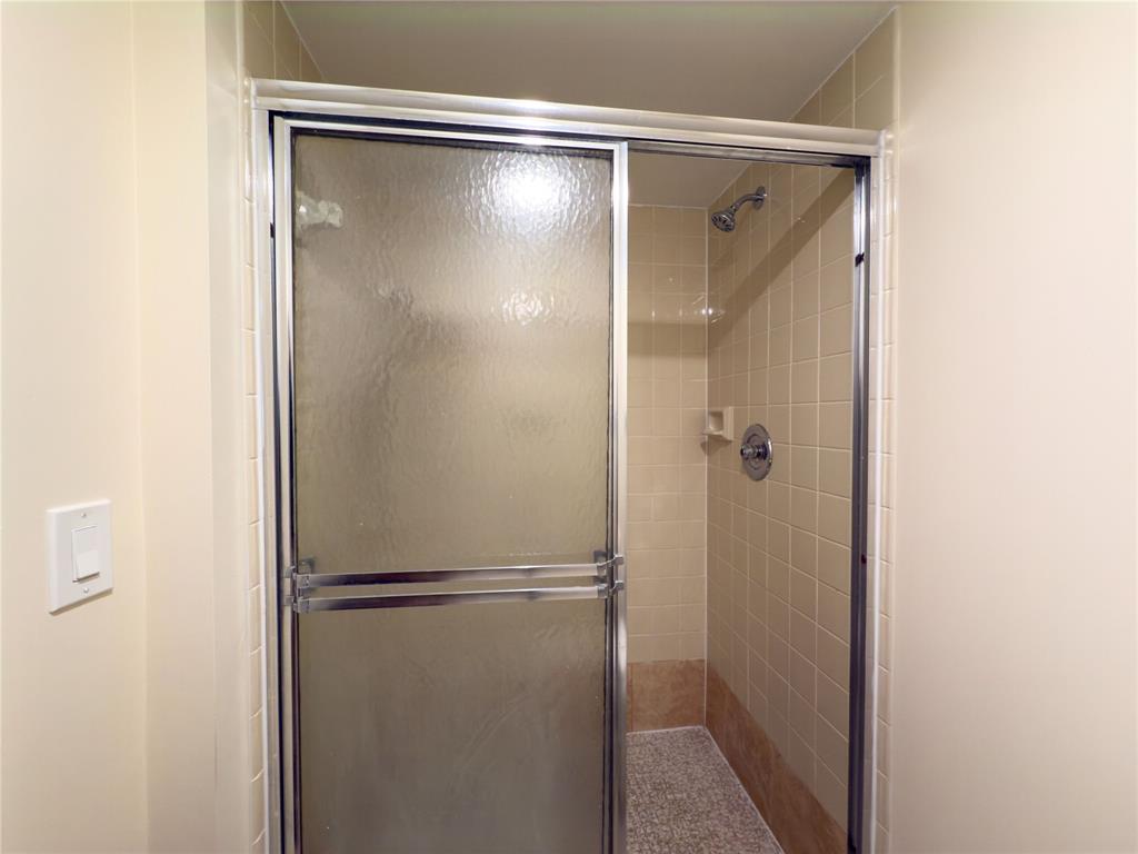 1701 Whitehall Drive, Unit 303 Davie, FL 33324 - Photo 30 of 33 a bathroom with a glass shower door