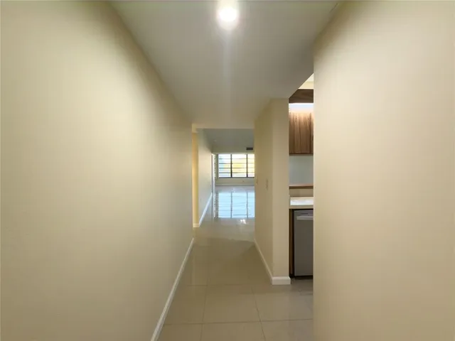 a view of an empty room with a ceiling fan