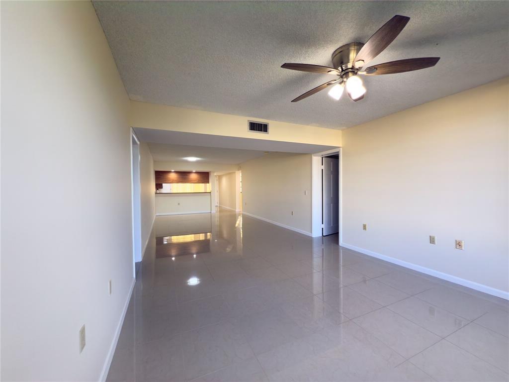 1701 Whitehall Drive, Unit 303 Davie, FL 33324 - Photo 5 of 33 a view of an empty room with a ceiling fan