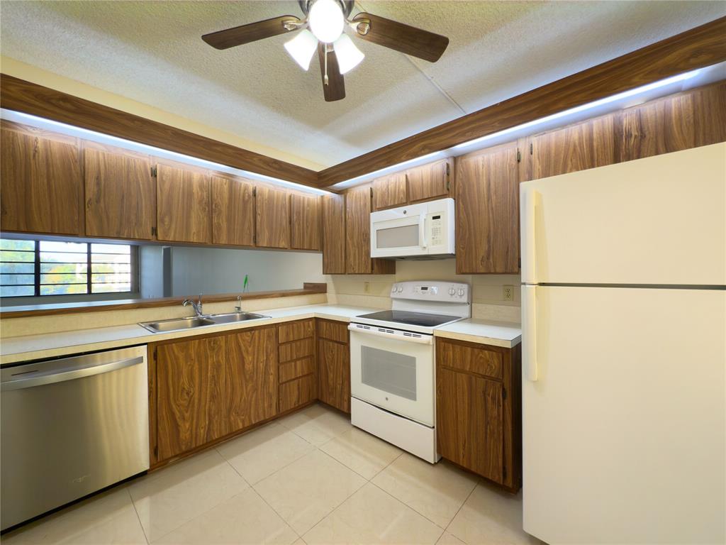 1701 Whitehall Drive, Unit 303 Davie, FL 33324 - Photo 10 of 33 a kitchen with a sink cabinets and appliances