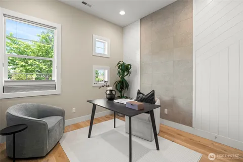 a living room with furniture and a potted plant