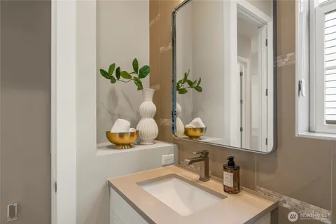 a bathroom with a sink a mirror and a window