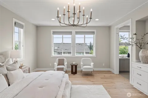 a bedroom with furniture and a large window