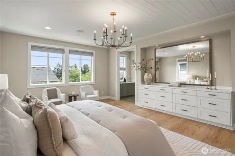 a bedroom with a large bed and a dresser