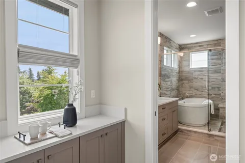 a bathroom with a toilet sink vanity and mirror