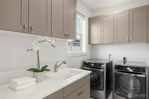 a kitchen with a sink and a stove top oven