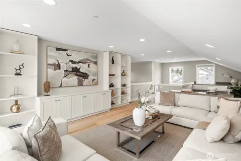 a living room with furniture and view of kitchen