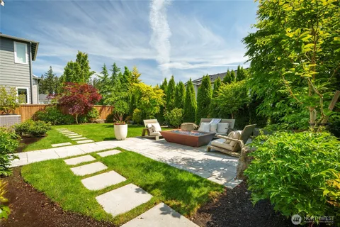 a view of a backyard with sitting area