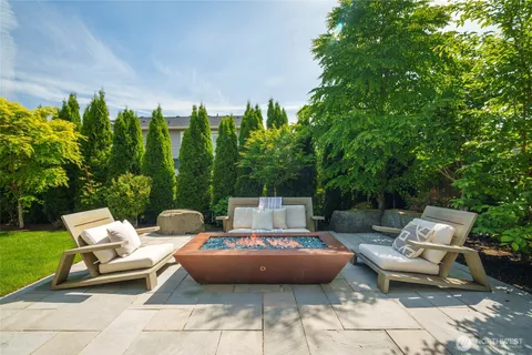 a view of a patio with a chairs and plants