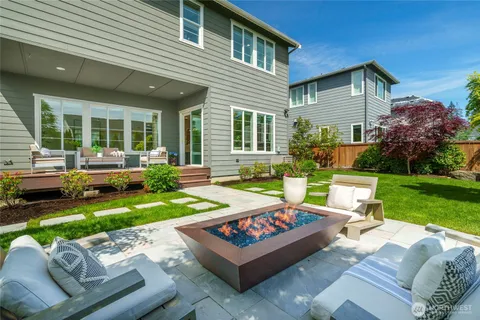 a view of a house with backyard sitting area and garden