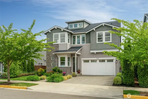 a front view of a house with a yard and potted plants