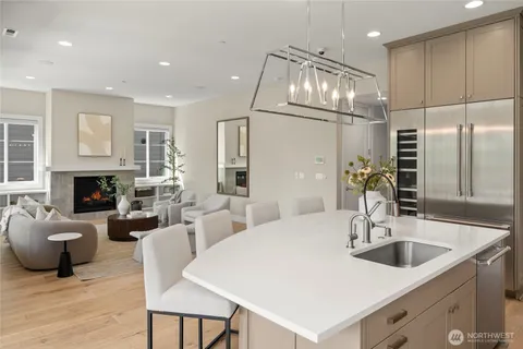 a kitchen with furniture a refrigerator and a sink