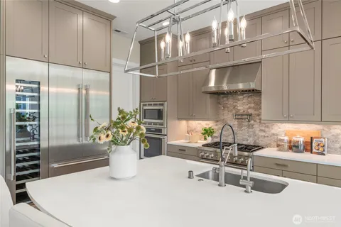 a kitchen with a refrigerator and a sink