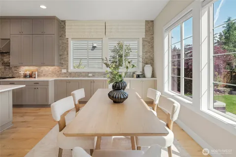 a kitchen with a table chairs and entryway